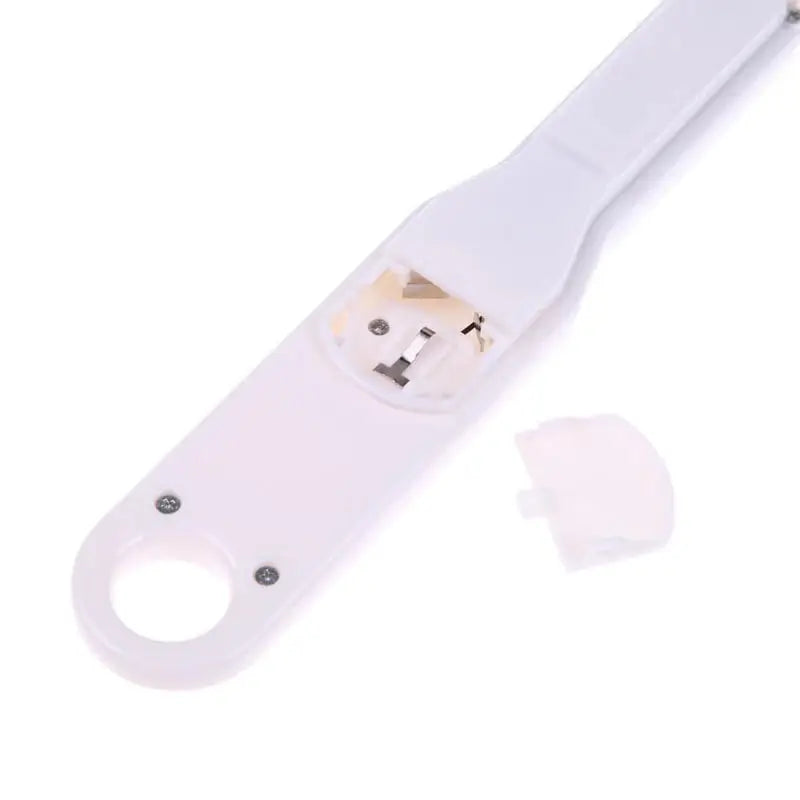 White plastic device with open battery compartment.